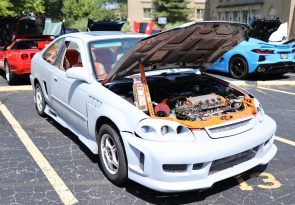 car with hood open, engine exposed